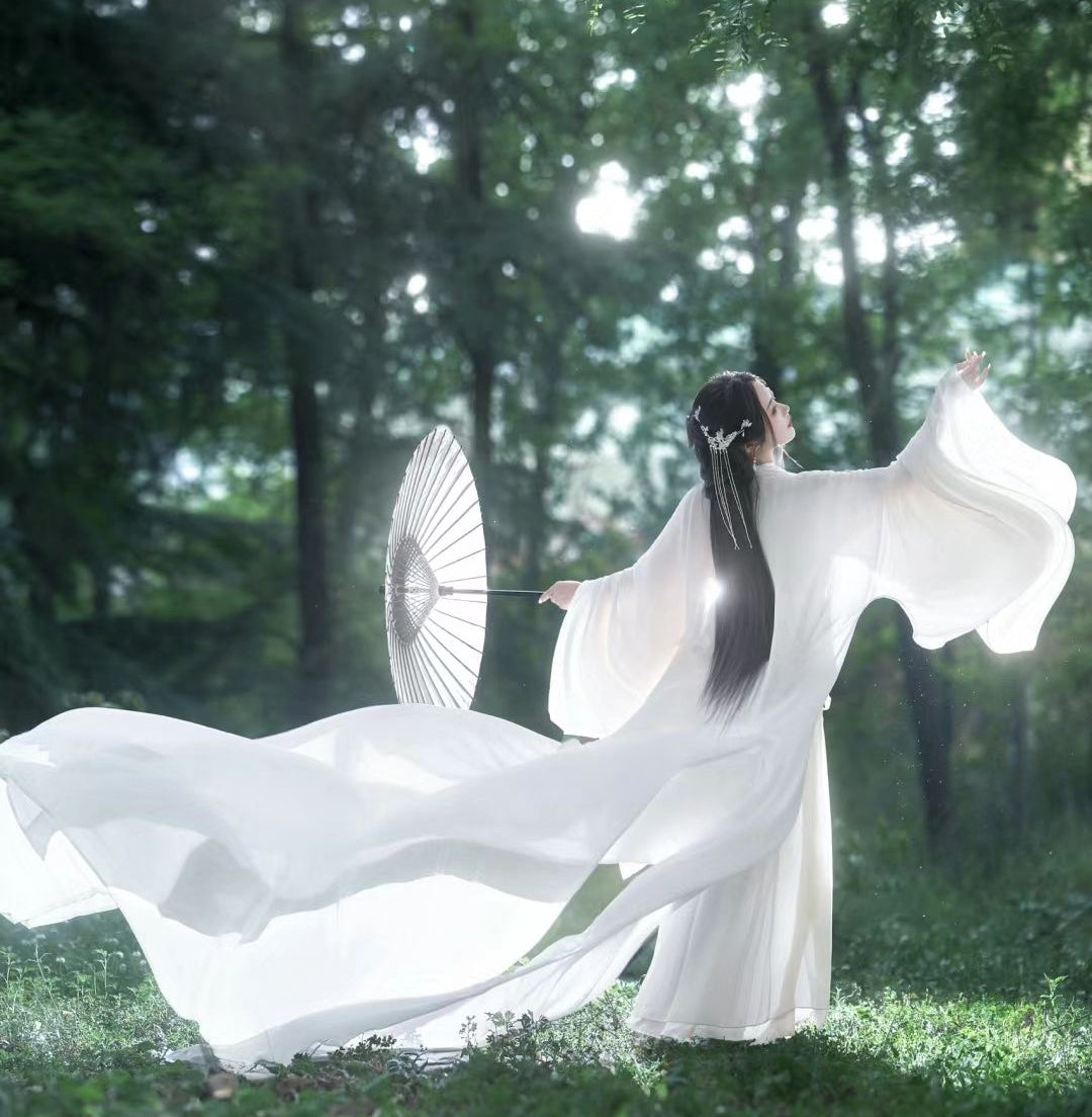 Ethereal woman in white hanbok holding a parasol, reaching skyward among cherry blossoms — evoking the elegance of the Joseon Dynasty and symbolizing Seonyo’s mission of graceful transformation through ancient Korean wellness rituals